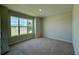 Sunlit bedroom boasts a large window with neighborhood views, creating a bright and inviting atmosphere at 329 Lady Palm St, Apopka, FL 32703