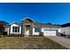 Single-story home with stone accents and a two-car garage at 329 Lady Palm St, Apopka, FL 32703