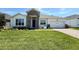 Charming single-story home featuring a well-manicured lawn and beautiful stone accents at 329 Lady Palm St, Apopka, FL 32703