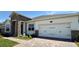 Attached two-car garage with brick paver driveway and professionally landscaped front yard at 329 Lady Palm St, Apopka, FL 32703
