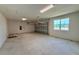Spacious garage with natural light streaming in from the window offering ample space for vehicles and storage at 329 Lady Palm St, Apopka, FL 32703