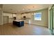 Spacious eat in kitchen with white cabinetry, stainless appliances, and island with sink at 329 Lady Palm St, Apopka, FL 32703