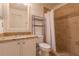 Bathroom with granite countertop, white cabinets, and a shower with tile surround at 5058 Maxon S Ter # 108, Sanford, FL 32771