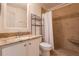 Bathroom with granite countertop, white cabinets, and a shower with tile surround at 5058 Maxon S Ter # 108, Sanford, FL 32771