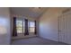 Carpeted bedroom with vaulted ceiling, large window, and ceiling fan at 5058 Maxon S Ter # 108, Sanford, FL 32771