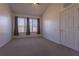 Carpeted bedroom with vaulted ceiling, window with curtains and a door at 5058 Maxon S Ter # 108, Sanford, FL 32771