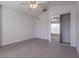 Bedroom with carpet, ceiling fan, double doors, and mirrored closet at 5058 Maxon S Ter # 108, Sanford, FL 32771