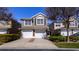 Two-story townhome with a two-car garage and well-maintained landscaping at 5058 Maxon S Ter # 108, Sanford, FL 32771