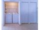 Laundry closet with washer, dryer, and shelving at 5058 Maxon S Ter # 108, Sanford, FL 32771