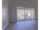 Bright living room with sliding glass doors leading to a balcony and view of trees at 5058 Maxon S Ter # 108, Sanford, FL 32771