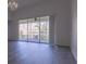 Living room features hardwood floors and sliding glass doors to balcony at 5058 Maxon S Ter # 108, Sanford, FL 32771