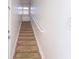 Carpeted staircase with white railing at 5058 Maxon S Ter # 108, Sanford, FL 32771
