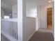 Upstairs hallway with railing overlooking living area at 5058 Maxon S Ter # 108, Sanford, FL 32771