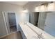 Bathroom with double vanity, large mirror, and access to walk-in closet at 791 Pilea St, Apopka, FL 32703