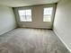 Bright carpeted bedroom with two windows offering neighborhood views at 791 Pilea St, Apopka, FL 32703