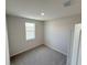 Carpeted bedroom with a window offering natural light and neighborhood views at 791 Pilea St, Apopka, FL 32703