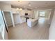 Bright kitchen with white cabinets, stainless steel appliances, quartz countertops, and an island with a sink at 791 Pilea St, Apopka, FL 32703