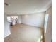 Open-concept living room with wood-look tile flooring leading to a modern kitchen, offering ample natural light at 791 Pilea St, Apopka, FL 32703