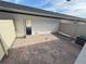 Brick-paved backyard patio with a white fence and access door at 791 Pilea St, Apopka, FL 32703