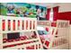Delightful bedroom featuring bunkbeds with red and black bedding and a Disney themed wall at 2621 Calistoga Ave, Kissimmee, FL 34741