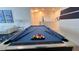 Second floor loft game room with a blue pool table and seating area at 2621 Calistoga Ave, Kissimmee, FL 34741