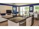 Modern kitchen with stainless steel appliances, dark countertops, and open view to the living area at 2621 Calistoga Ave, Kissimmee, FL 34741