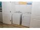 A well lit laundry room with a white washer and dryer at 2621 Calistoga Ave, Kissimmee, FL 34741