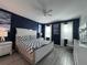 Comfortable main bedroom with a king size bed, stylish décor, and ensuite bathroom at 2621 Calistoga Ave, Kissimmee, FL 34741