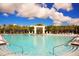 A large community pool with waterfall feature, palm trees, and blue sky offers a resort-like feel at 2621 Calistoga Ave, Kissimmee, FL 34741