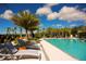 Relaxing poolside setting with lounge chairs and palm trees overlooking the sparkling pool at 2621 Calistoga Ave, Kissimmee, FL 34741