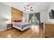 Main bedroom with wood-paneled accent wall and sliding glass doors to patio at 8162 Lazy Bear Ln, Winter Park, FL 32792