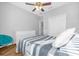Bright bedroom with striped bedding, ceiling fan, and ample closet space at 8162 Lazy Bear Ln, Winter Park, FL 32792