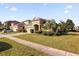 House exterior with a driveway, landscaping, and American flag at 8162 Lazy Bear Ln, Winter Park, FL 32792