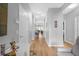 Hardwood-floored hallway with light walls and access to other rooms at 8162 Lazy Bear Ln, Winter Park, FL 32792