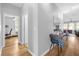 Light and airy hallway with hardwood floors and views into other rooms at 8162 Lazy Bear Ln, Winter Park, FL 32792