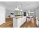 Open concept kitchen with island and view into living area at 8162 Lazy Bear Ln, Winter Park, FL 32792