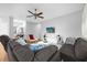 Bright living room features comfy sectional sofa, accent chairs, and a large flat-screen TV at 8162 Lazy Bear Ln, Winter Park, FL 32792