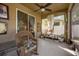 Cozy screened porch with wicker furniture and potted plants at 8162 Lazy Bear Ln, Winter Park, FL 32792