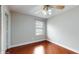 Well-lit bedroom with hardwood floors, neutral walls, and a ceiling fan at 1278 Snug Harbor Dr, Casselberry, FL 32707
