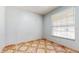 Cozy bedroom featuring patterned tile floor, a window with blinds, and neutral wall color at 1278 Snug Harbor Dr, Casselberry, FL 32707
