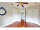 This cozy bedroom features hardwood floors, a ceiling fan, and neutral paint at 1278 Snug Harbor Dr, Casselberry, FL 32707