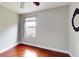 Empty bedroom with hardwood floors, one window and a mirror at 1278 Snug Harbor Dr, Casselberry, FL 32707