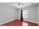 A cozy bedroom features hardwood floors, a ceiling fan, and natural light from the window at 1278 Snug Harbor Dr, Casselberry, FL 32707