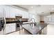 Well-equipped kitchen boasting a center island with bar seating, and a mosaic tile backsplash at 1278 Snug Harbor Dr, Casselberry, FL 32707