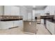 Beautiful kitchen with white cabinets, dark countertops, stainless steel appliances, and a functional center island at 1278 Snug Harbor Dr, Casselberry, FL 32707