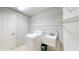 This laundry room has a sink, washer, and shelving for ample storage at 1278 Snug Harbor Dr, Casselberry, FL 32707