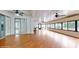 Large living room with wood floors, ceiling fan, sliding glass doors, and an abundance of natural light at 1278 Snug Harbor Dr, Casselberry, FL 32707