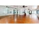 Spacious living room featuring hardwood floors, ceiling fans, and ample natural light from the many windows at 1278 Snug Harbor Dr, Casselberry, FL 32707