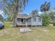 Exterior view of the back of house featuring a small porch and backyard at 1017 Mabbette St, Kissimmee, FL 34741