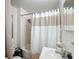 Bathroom featuring a shower with a curtain, toilet, sink and mirror at 1017 Mabbette St, Kissimmee, FL 34741